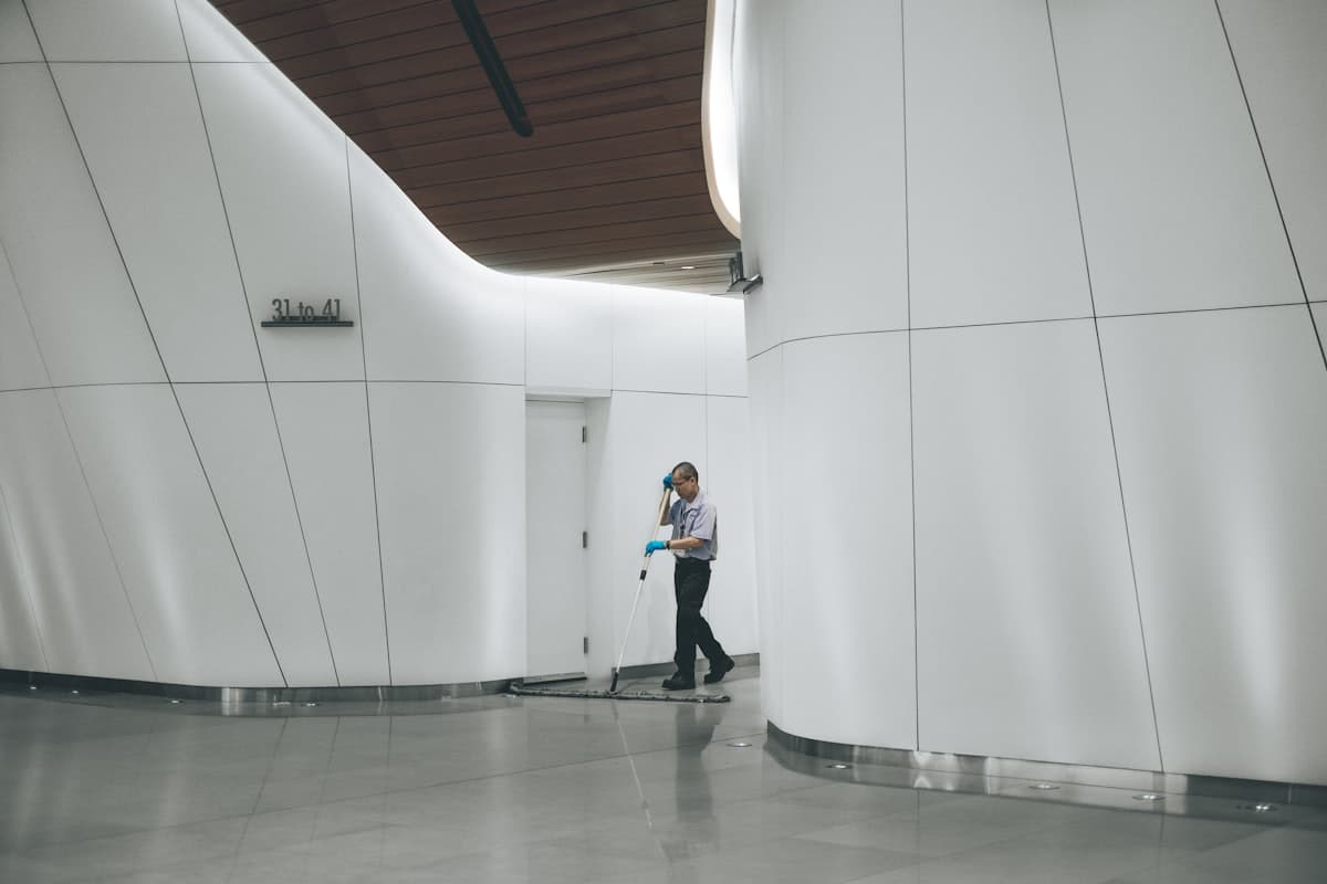 Commercial cleaner polishing an open-plan office floor in a Modesto workspace after hours