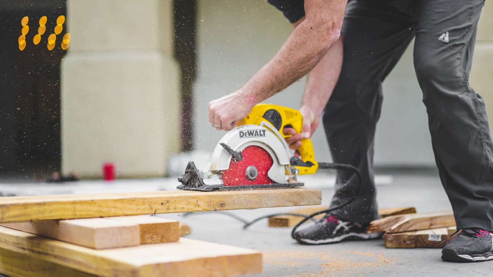 Handyman repairing a kitchen cabinet with a cordless drill