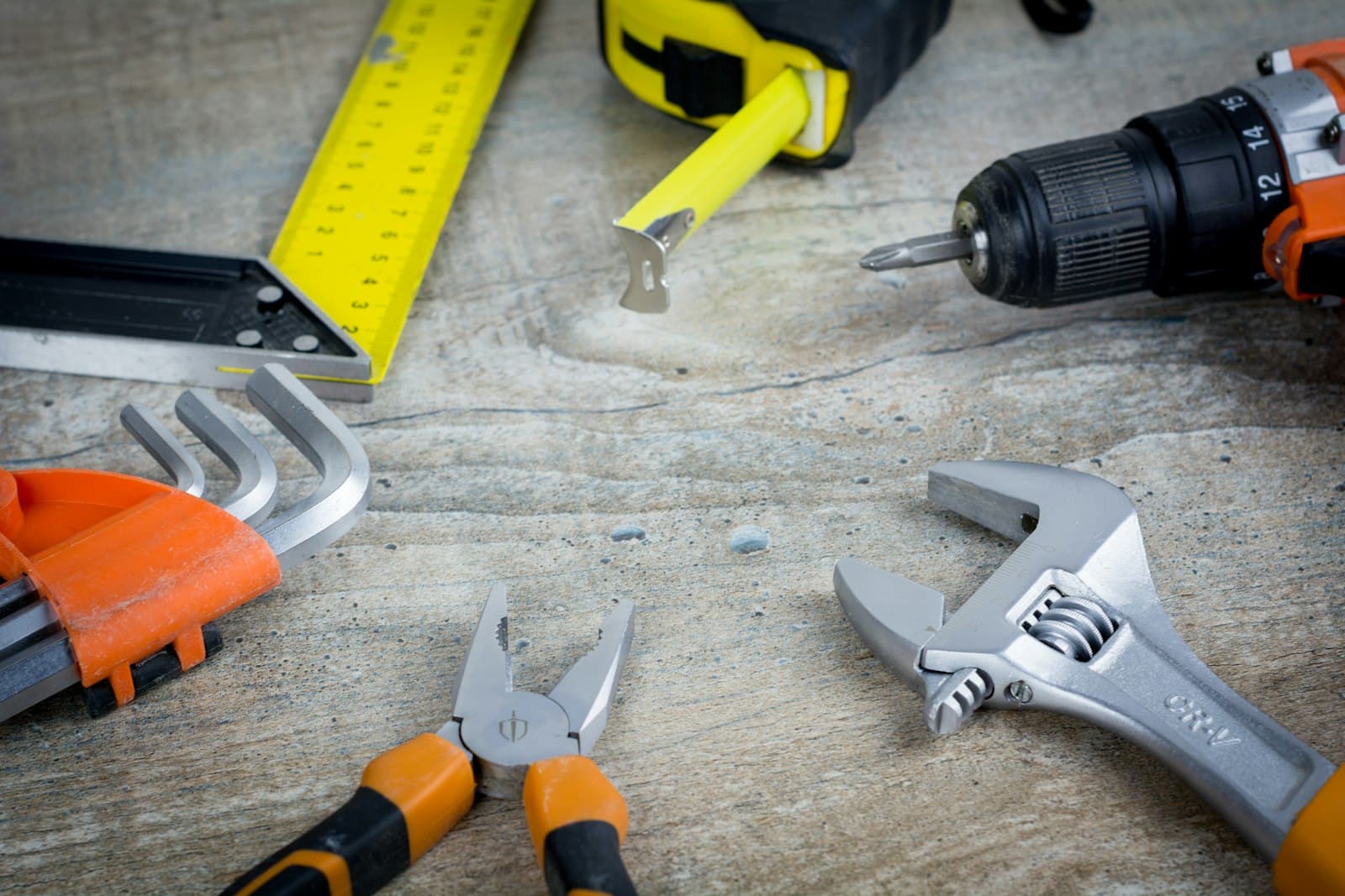 Handyman's organized toolkit laid out on a worksite tarp
