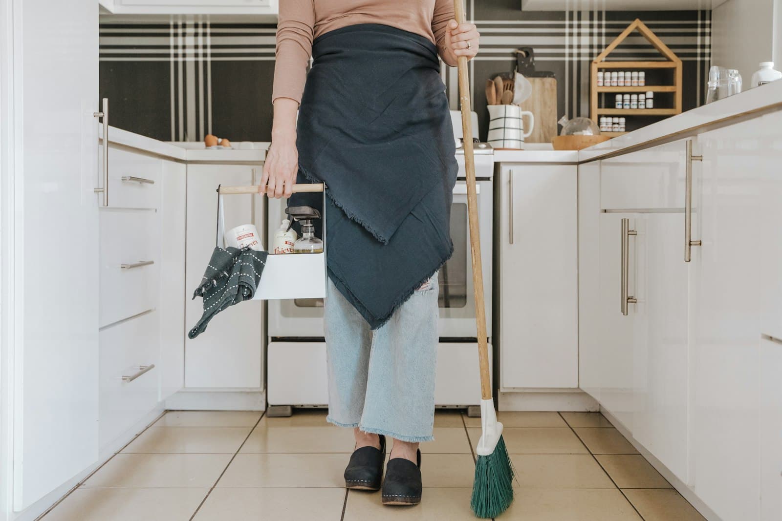 Professional house cleaner wiping a clean kitchen counter in a sunlit Modesto home